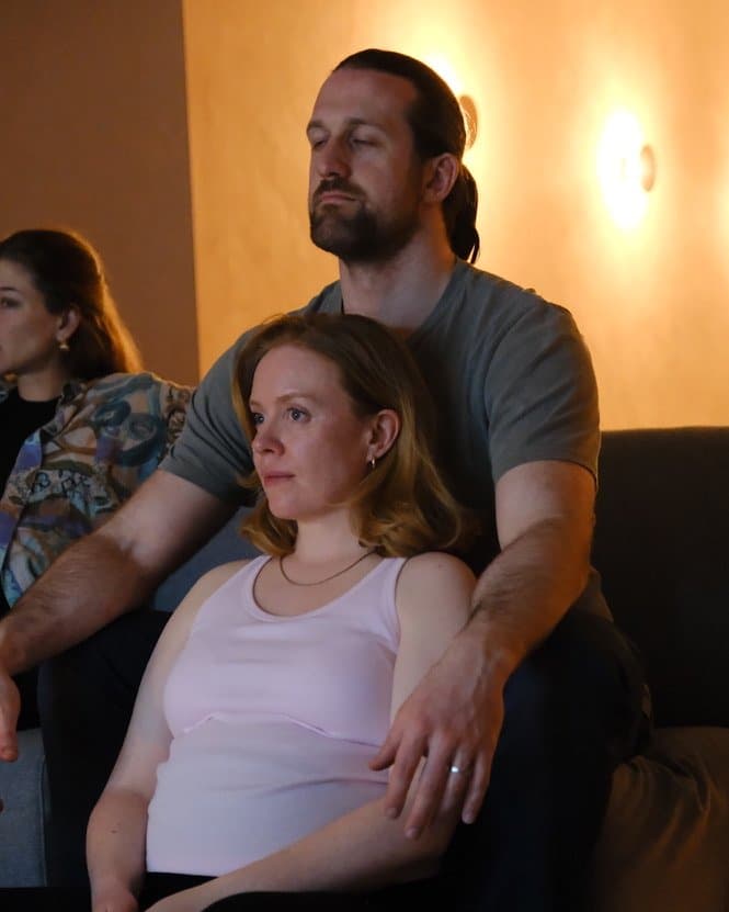 Expectant parents practicing relaxation techniques during a hypnobirthing course